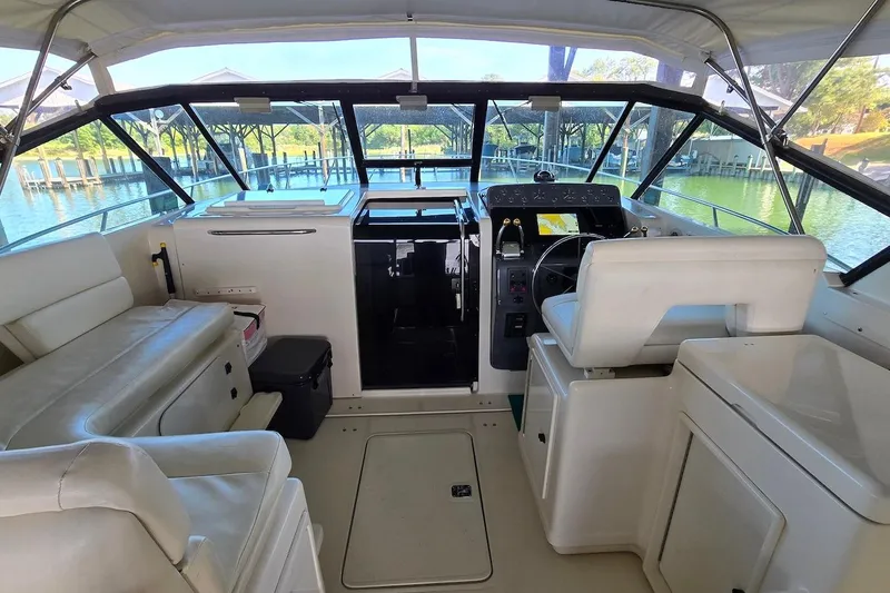 Slide: The Image of 1996 Tiara Yachts 3700 Open docked, showcasing sleek design and spacious deck. - 22