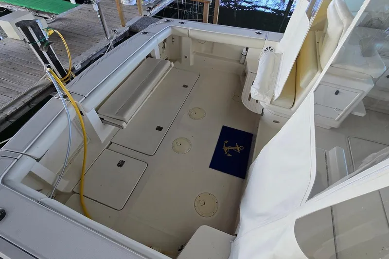 Slide: The Image of 1996 Tiara Yachts 3700 Open helm with navigation equipment and seating. - 28