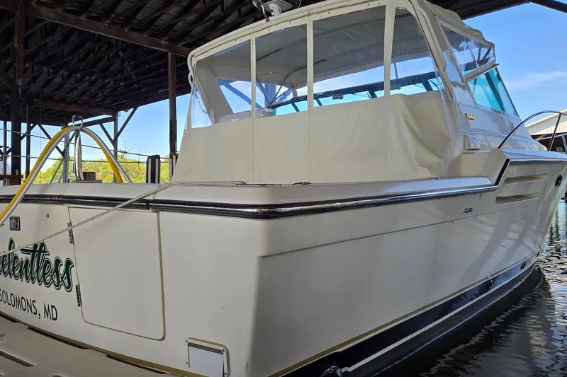 Slide: The Image of 1996 Tiara Yachts 3700 Open helm with steering wheel, navigation screen, and controls. - 29