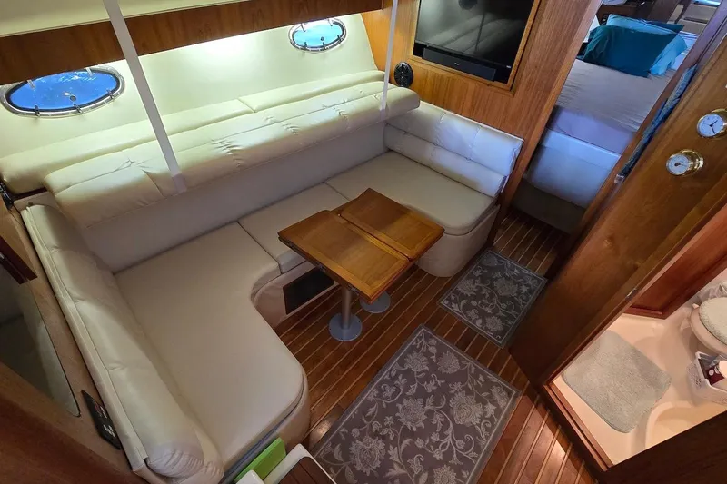 Slide: The Image of Interior view of 1996 Tiara Yachts 3700 Open, featuring seating and dockside scenery. - 32