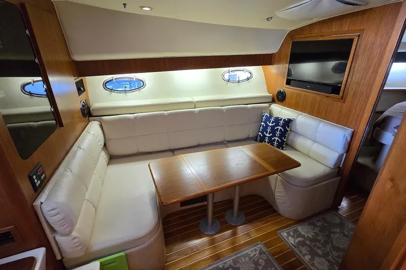 Slide: The Image of 1996 Tiara Yachts 3700 Open cockpit with seating and storage, docked at marina. - 33