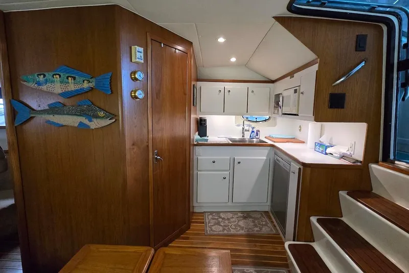 Slide: The Image of 1996 Tiara Yachts 3700 Open docked in a marina, rear view with canopy. - 35