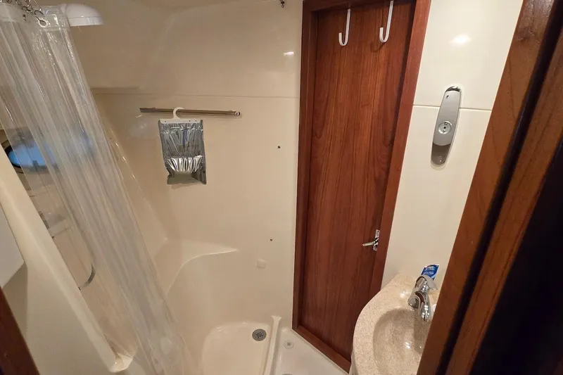 Slide: The Image of 1996 Tiara Yachts 3700 Open cockpit with seating and storage, docked at marina. - 36