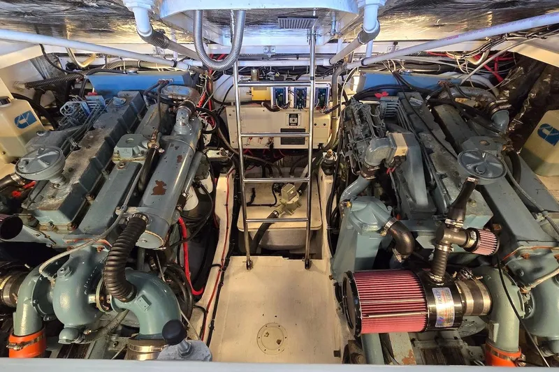 Slide: The Image of Engine room of a 1996 Tiara Yachts 3700 Open, showcasing dual engines and mechanical components. - 48