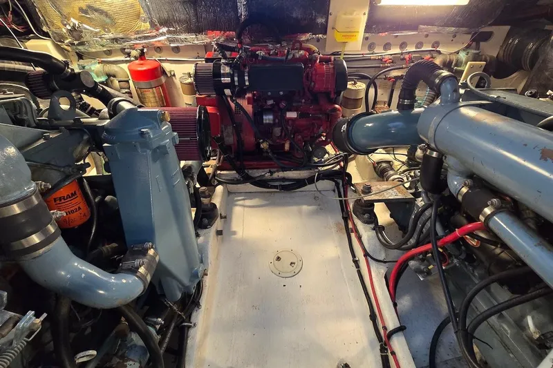 Slide: The Image of Engine room of a 1996 Tiara Yachts 3700 Open, showcasing mechanical components and wiring. - 49