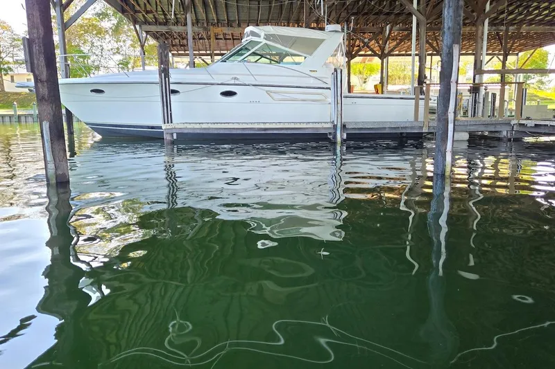 Slide: The Image of 1996 Tiara Yachts 3700 Open docked in a covered marina. - 6