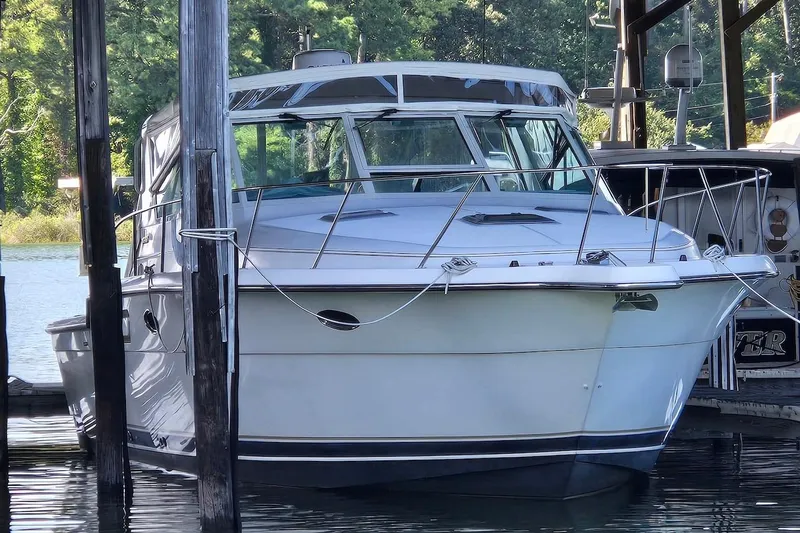 Slide: The Image of 1996 Tiara Yachts 3700 Open docked, rear view with covered seating area. - 8