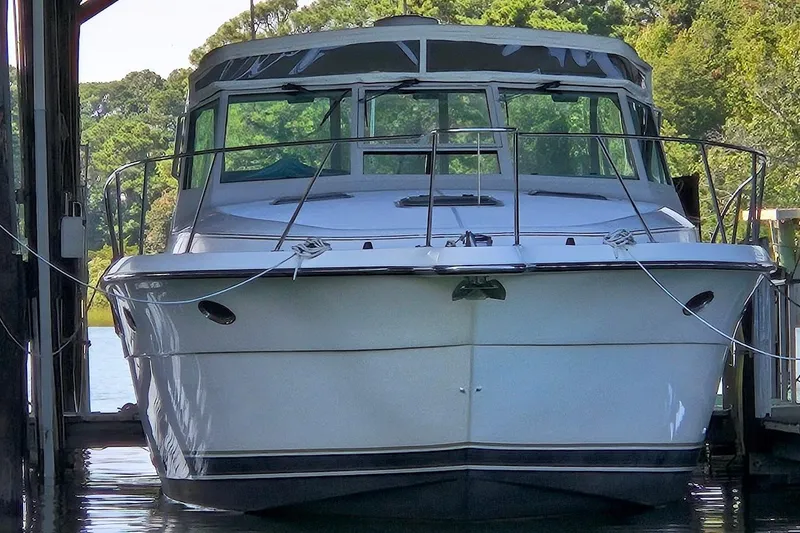 Slide: The Image of 1996 Tiara Yachts 3700 Open docked in a covered marina, rear view. - 9