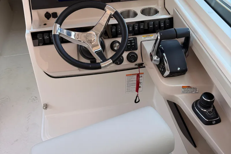 Slide: The Image of 2025 Boston Whaler 280 Vantage boat interior with vibrant blue and red lighting. - 10
