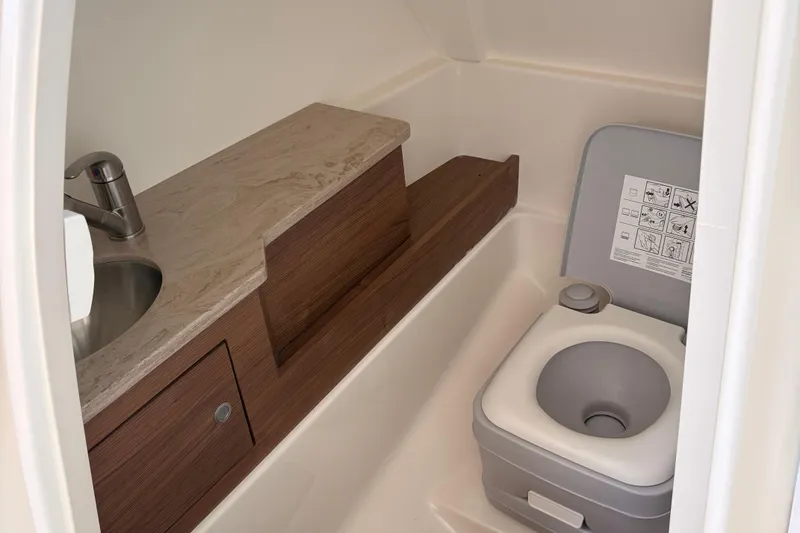 Slide: The Image of 2025 Boston Whaler 280 Vantage interior with ambient blue lighting and modern dashboard. - 11