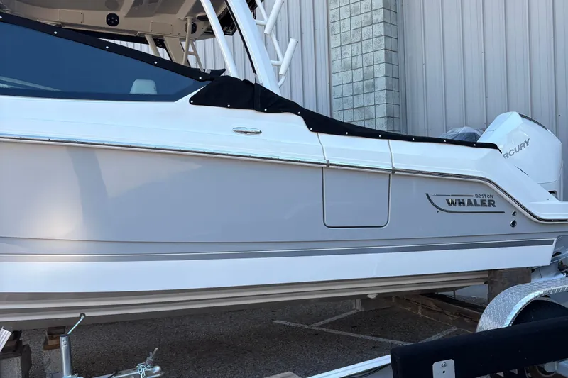 Slide: The Image of 2025 Boston Whaler 280 Vantage interior with vibrant blue and purple lighting. - 14