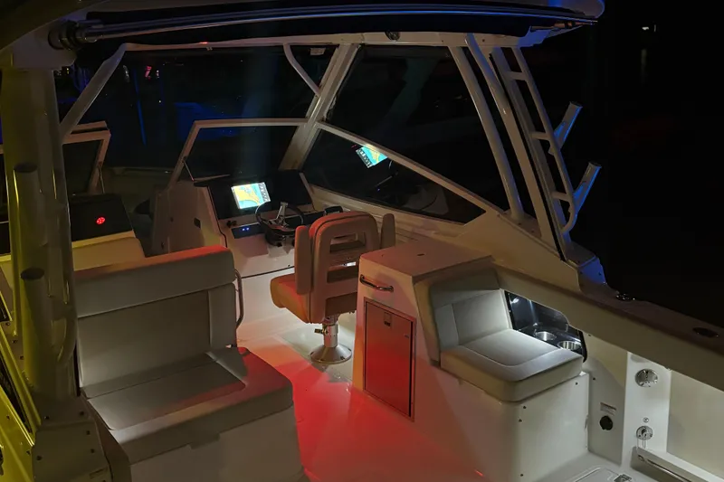 Slide: The Image of 2025 Boston Whaler 280 Vantage boat seat with Mercury engine in background. - 4