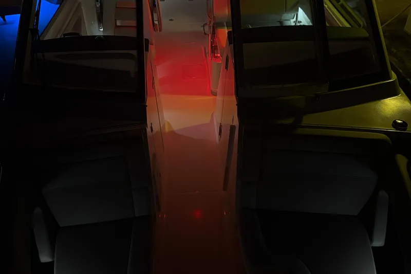 Slide: The Image of 2025 Boston Whaler 280 Vantage interior with beige seating and cup holders. - 5