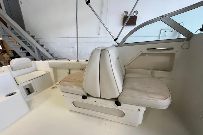 Slide: The Image of 2006 Hydra-Sports Lightning 202 DC boat interior with white seating and storage compartments. - 12