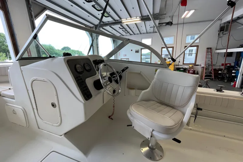 Slide: The Image of 2006 Hydra-Sports Lightning 202 DC boat interior with steering wheel and captain's chair. - 15