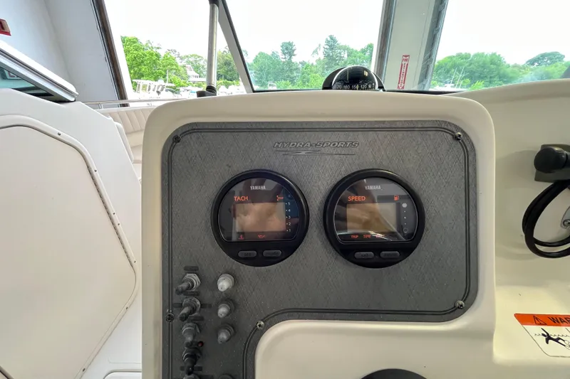 Slide: The Image of 2006 Hydra-Sports Lightning 202 DC dashboard with Yamaha tachometer and speedometer gauges. - 16