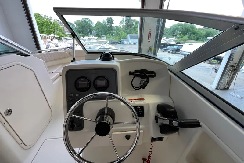 Slide: The Image of 2006 Hydra-Sports Lightning 202 DC boat helm with steering wheel and control panel. - 17