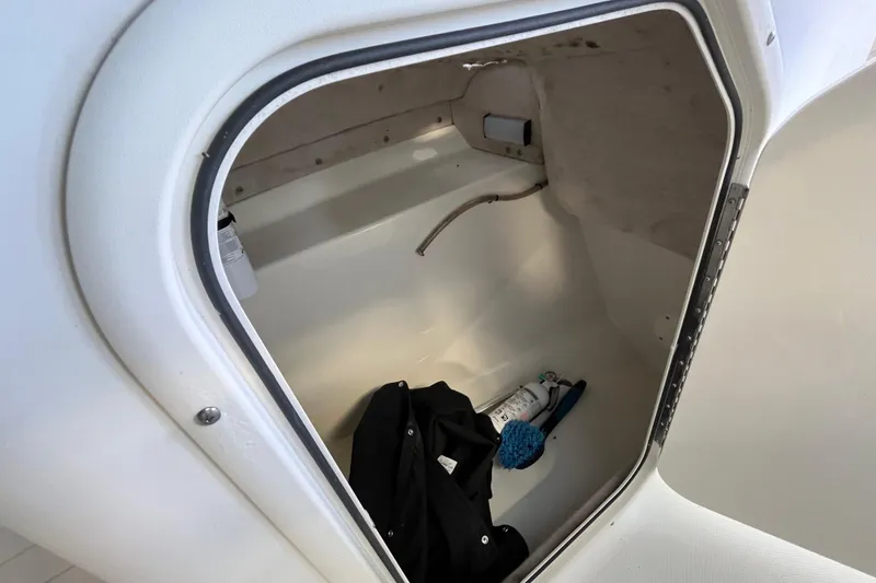 Slide: The Image of Storage compartment of 2006 Hydra-Sports Lightning 202 DC boat, containing cleaning supplies. - 18