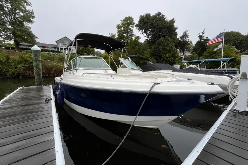Slide: The Image of 2006 Hydra-Sports Lightning 202 DC boat docked, featuring sleek design and canopy. - 2
