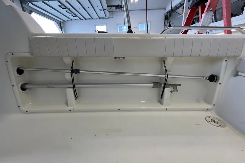 Slide: The Image of 2006 Hydra-Sports Lightning 202 DC boat interior storage compartment with rods and equipment. - 20