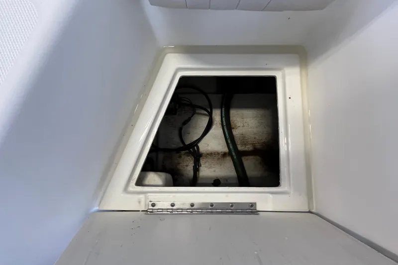 Slide: The Image of 2006 Hydra-Sports Lightning 202 DC storage compartment with visible wiring and hoses. - 22