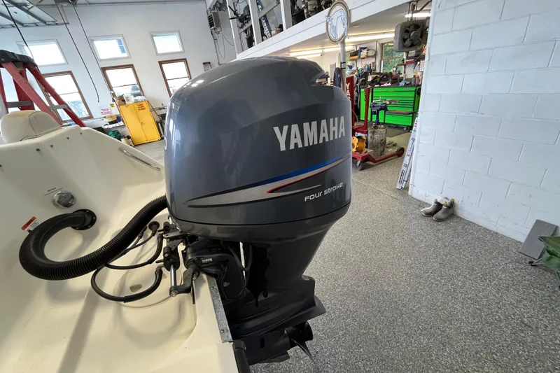 Slide: The Image of 2006 Hydra-Sports Lightning 202 DC with Yamaha four-stroke outboard in a garage setting. - 25