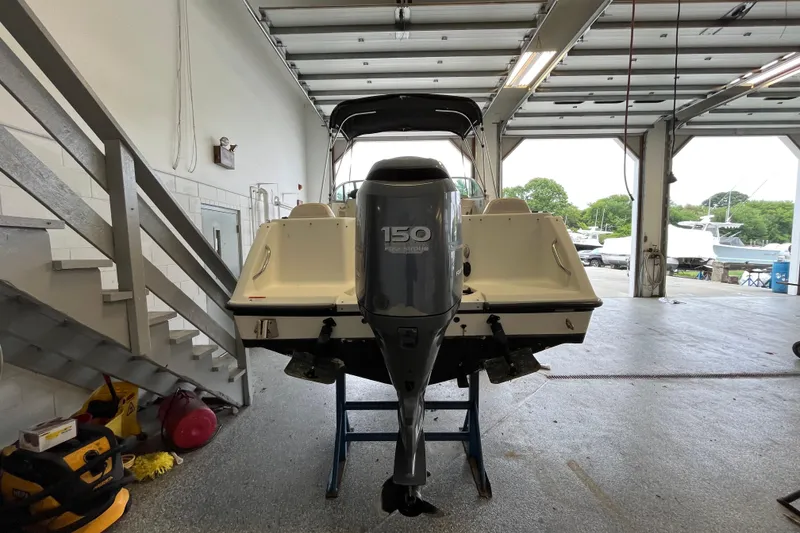 Slide: The Image of 2006 Hydra-Sports Lightning 202 DC boat with 150 horsepower engine in a garage. - 27
