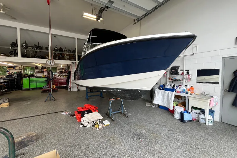 Slide: The Image of 2006 Hydra-Sports Lightning 202 DC boat in a garage workshop setting. - 30