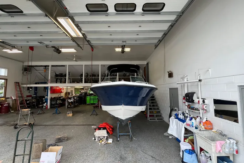Slide: The Image of 2006 Hydra-Sports Lightning 202 DC boat in a garage workshop setting. - 31