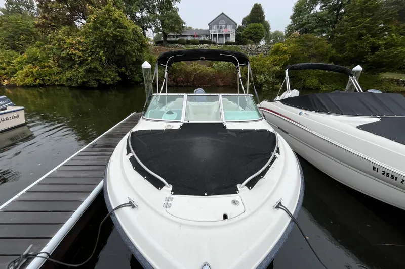 Slide: The Image of 2006 Hydra-Sports Lightning 202 DC boat docked on a serene lake. - 4