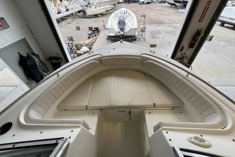 Slide: The Image of 2006 Hydra-Sports Lightning 202 DC boat interior with cushioned seating in a garage setting. - 5