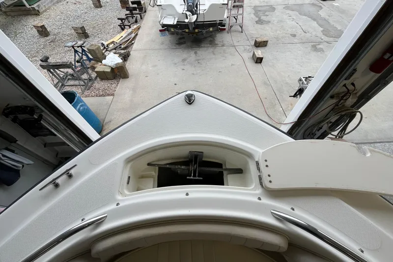 Slide: The Image of 2006 Hydra-Sports Lightning 202 DC boat in garage, viewed from bow, with open anchor compartment. - 8
