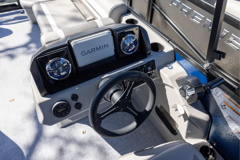 Slide: The Image of 2026 Premier 200 Sunscape RF boat dashboard with Garmin navigation system and steering wheel. - 10