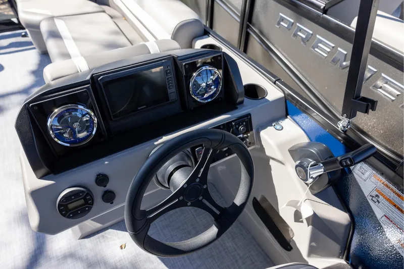 Slide: The Image of Steering console of 2026 Premier 200 Sunscape RF boat with modern controls and gauges. - 11