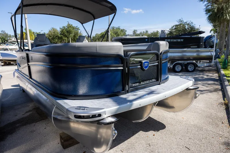 Slide: The Image of 2026 Premier 200 Sunscape RF pontoon boat with sleek design, parked outdoors. - 4