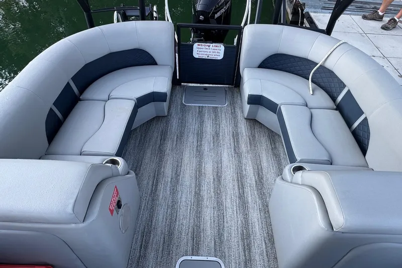 Slide: The Image of Luxurious seating area on 2025 Bennington 26 L Top Deck pontoon boat with cup holders. - 2