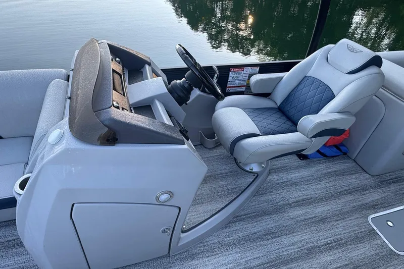 Slide: The Image of 2025 Bennington 26 L Top Deck boat interior with gray seating and carpeted floor. - 3