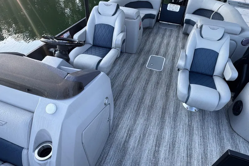 Slide: The Image of 2025 Bennington 26 L Top Deck boat interior with steering wheel and control panel. - 5