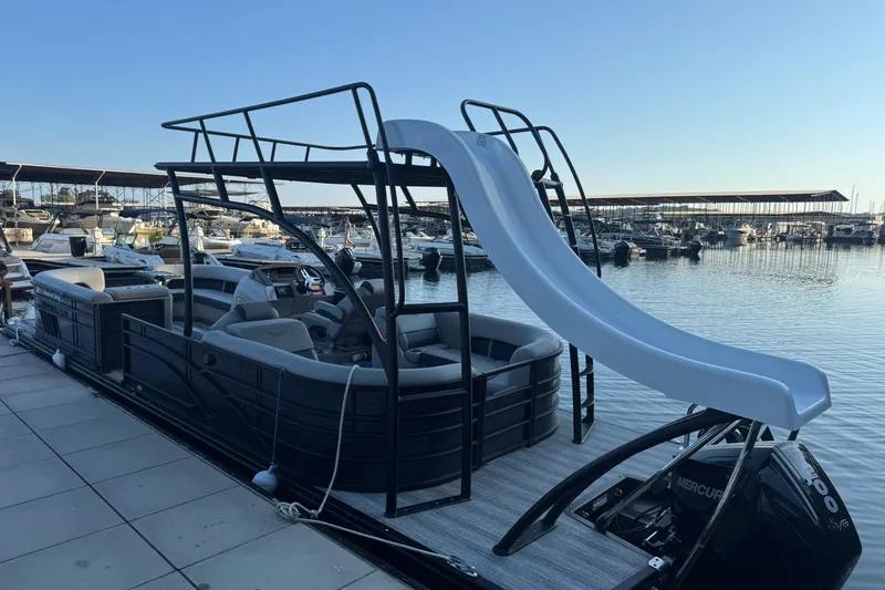 Slide: The Image of 2025 Bennington 26 L Top Deck boat interior with luxurious seating and modern steering console. - 7