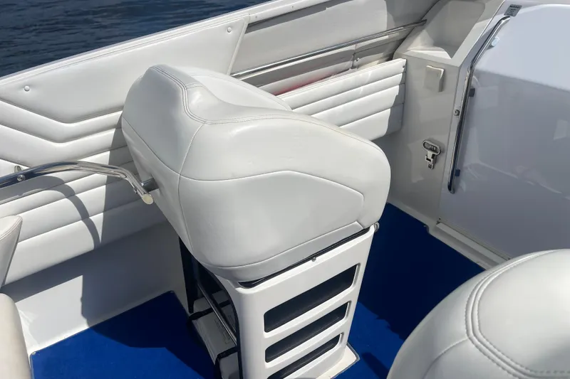 Slide: The Image of White interior seating of 1995 Excel Scarab 43 boat with blue carpet. - 19