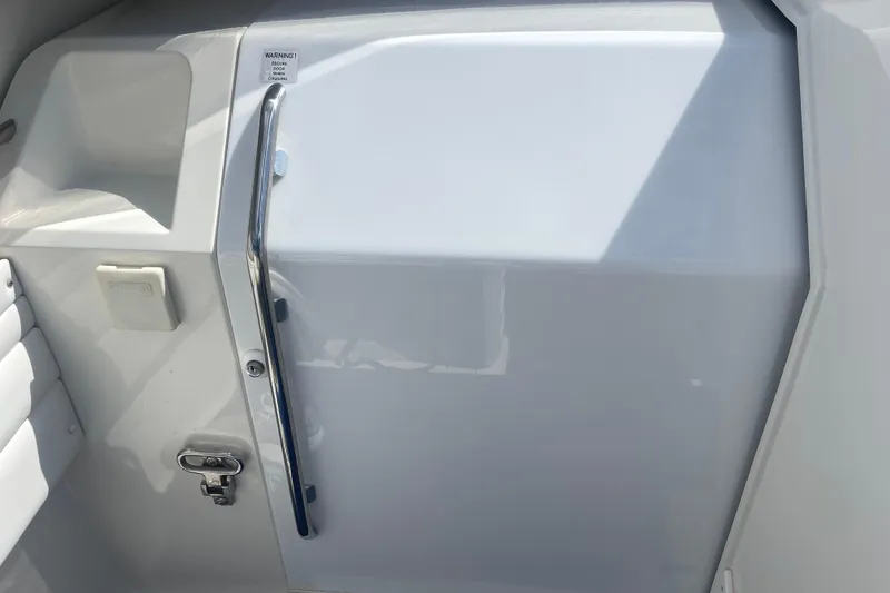 Slide: The Image of 1995 Excel Scarab 43 boat interior with sleek white panel and chrome handle. - 20