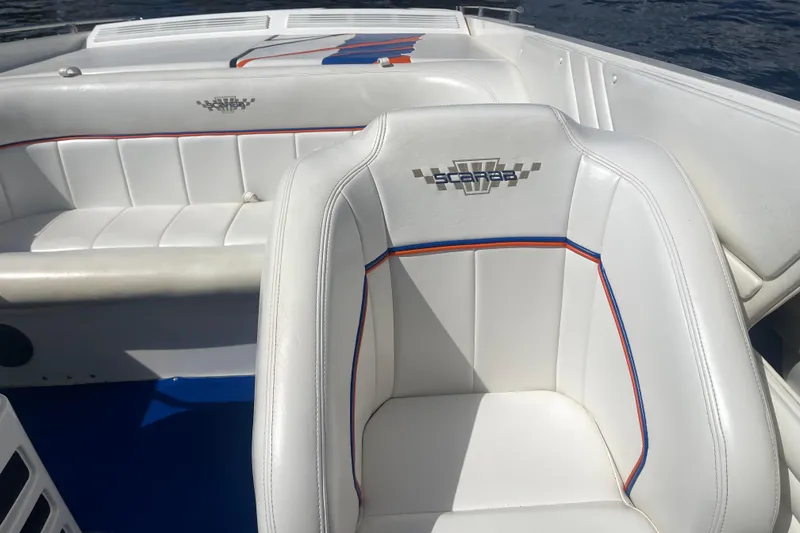 Slide: The Image of 1995 Excel Scarab 43 boat interior with white seating and colorful accents. - 21