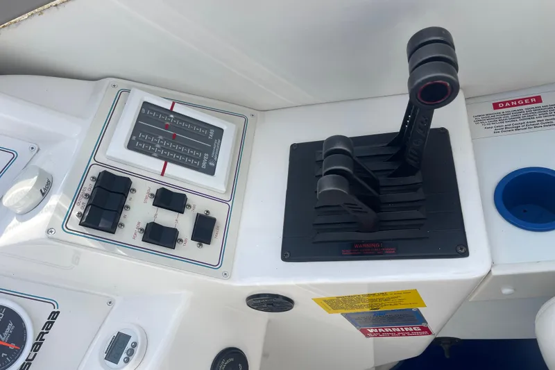 Slide: The Image of Control panel of a 1995 Excel Scarab 43 boat with throttle levers and switches. - 23