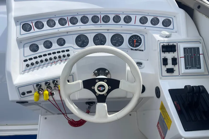 Slide: The Image of 1995 Excel Scarab 43 boat dashboard with steering wheel and control panel. - 24