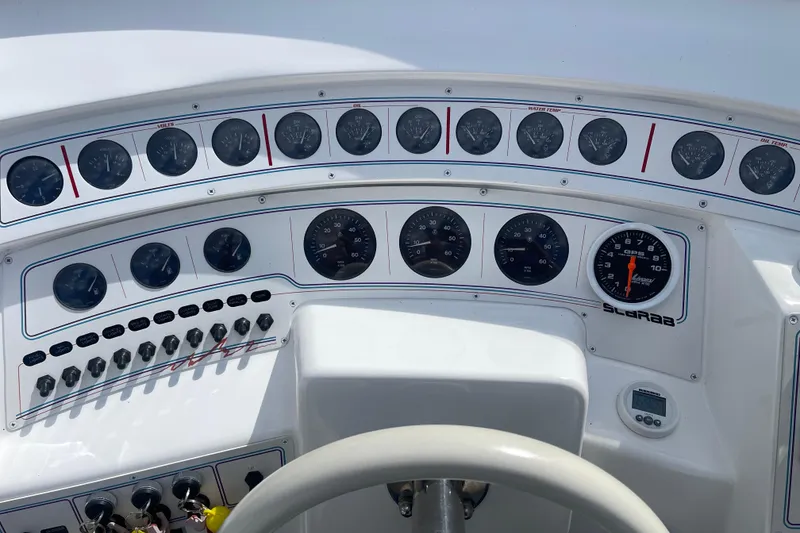 Slide: The Image of 1995 Excel Scarab 43 dashboard with gauges and controls, featuring speedometer and tachometer. - 25