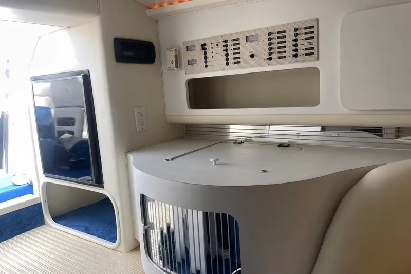 Slide: The Image of Interior of 1995 Excel Scarab 43 boat, featuring control panel and modern design elements. - 27