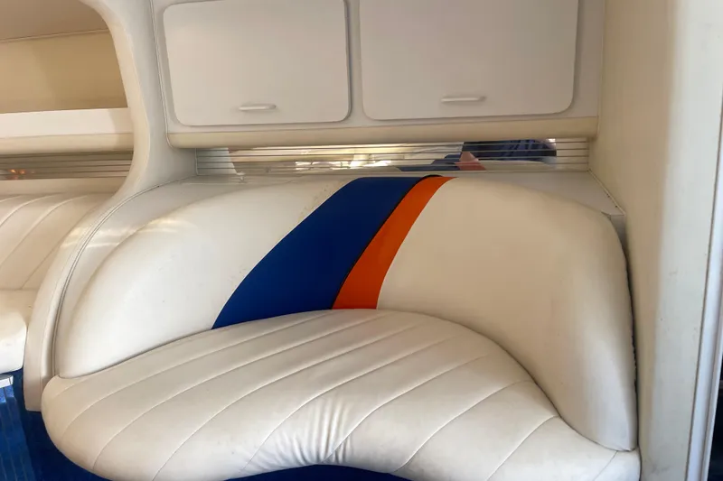 Slide: The Image of Interior of 1995 Excel Scarab 43 boat with white, blue, and orange seating. - 28
