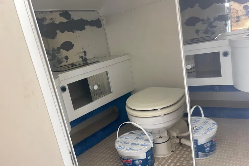 Slide: The Image of Interior of 1995 Excel Scarab 43 boat bathroom with toilet and storage cabinets. - 30
