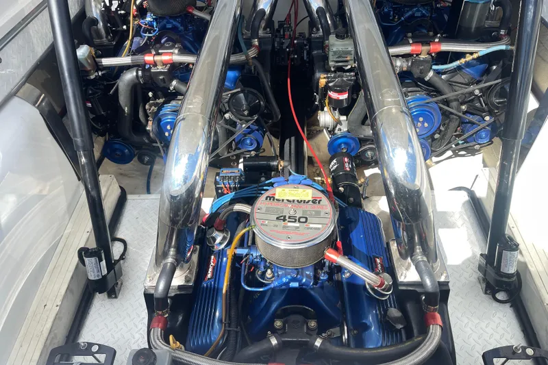 Slide: The Image of Engine compartment of a 1995 Excel Scarab 43 boat, featuring a powerful 450 horsepower engine. - 31