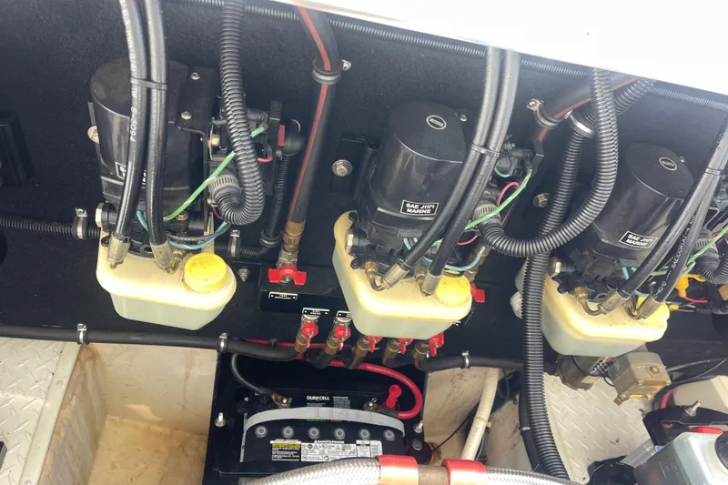 Slide: The Image of Engine compartment of a 1995 Excel Scarab 43 boat, showing hydraulic systems and wiring. - 33
